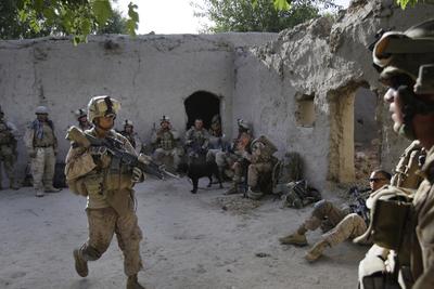 U.S. Marines from the 2nd Marine Expeditionary Brigade, 1st Battalion 5th Marines, temporarily occupy a house after arriving in an overnight air assault near the Taliban stronghold of Nawa in Afghanistan’s Helmand province on Thursday.  (Associated Press / The Spokesman-Review)