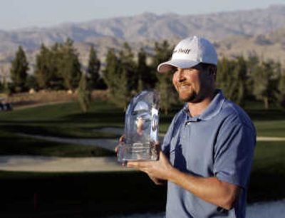 
D.J. Trahan holds his trophy after winning the Bob Hope Chrysler Classic golf tournament.
 (Associated Press / The Spokesman-Review)