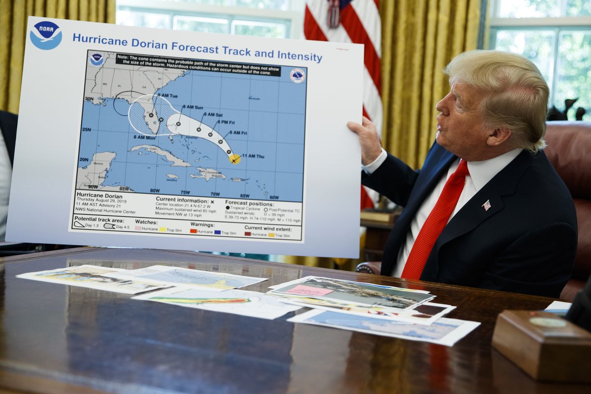 President Donald Trump holds a chart as he talks with reporters after receiving a briefing on Hurricane Dorian on Sept. 4 at the White House in Washington.  (Evan Vucci)