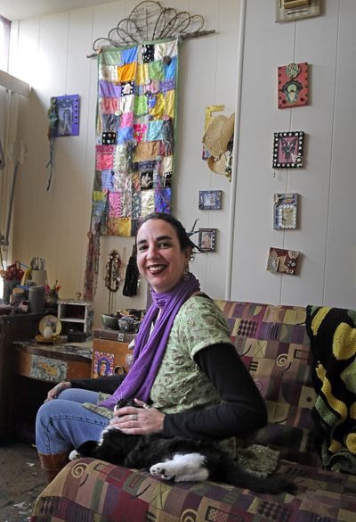 Dina Fernandez sits with her cat, Karma, in front of her patchwork quilt called “Spring” hanging on the wall.chrisa@spokesman.com (CHRISTOPHER ANDERSON)