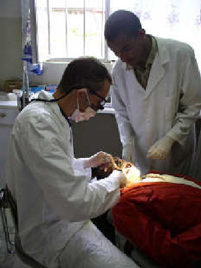
Zach Brumbach, a dentist from Post Falls, extracts a decayed tooth from an Ethiopian man.
 (Photo courtesy of Hope Brumbach / The Spokesman-Review)