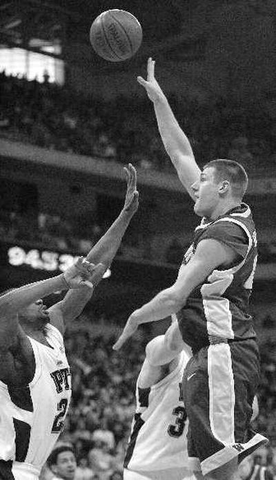 
Washington's Jon Brockman shoots over Pitt's Sam Young during Saturday's second half. 
 (Associated Press / The Spokesman-Review)