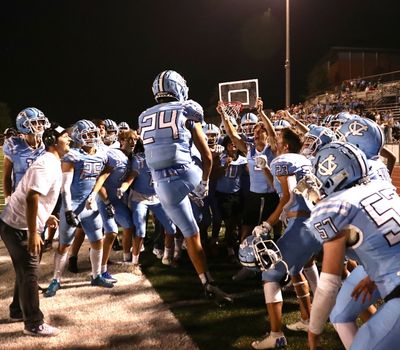 George Ditto, 24, celebrates with his team following his touchdown during their first game of the season.  (Erik Smith)