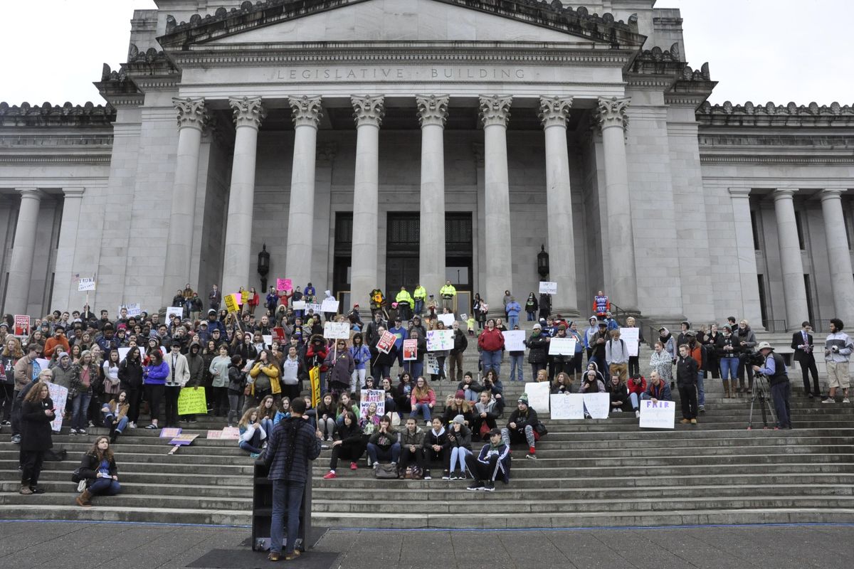 OLYMPIA – About 200 protesters gathered on the steps of the Washington Capitol Friday for a Youth Unity Rally against Donald Trump as the new president was being inaugurated in Washington, D.C. (Jim Camden / The Spokesman-Review)