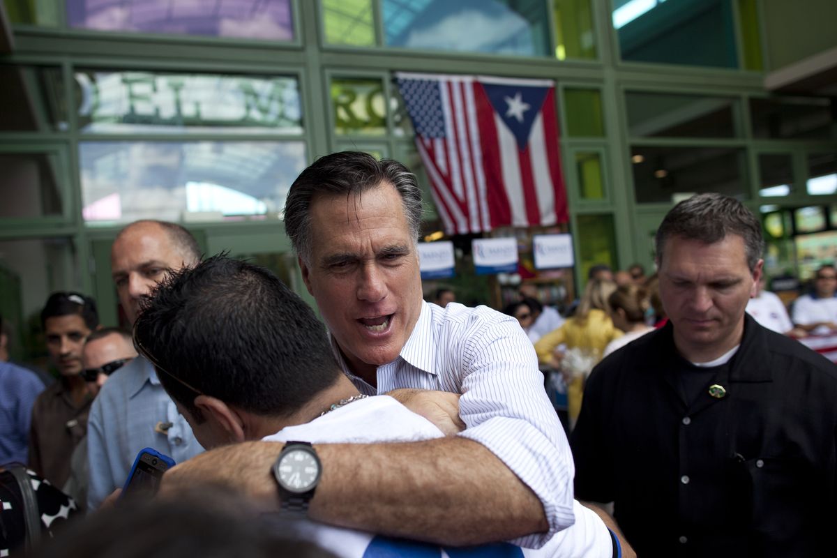 Republican presidential candidate and former Massachusetts Gov. Mitt Romney hugs a supporter during a campaign stop on Saturday in Bayamon, Puerto Rico.