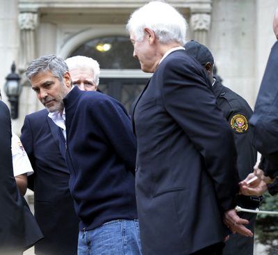 Actor George Clooney, center, Rep. Jim Moran, D-Va, back, and Clooney's father, Nick Clooney, right, are arrested during a protest at the Sudanese Embassy in Washington, Friday, March 16, 2012. The demonstrators are protesting the escalating humanitarian emergency in Sudan that threatens the lives of 500,000 people.  (Cliff Owen/Associated Press)