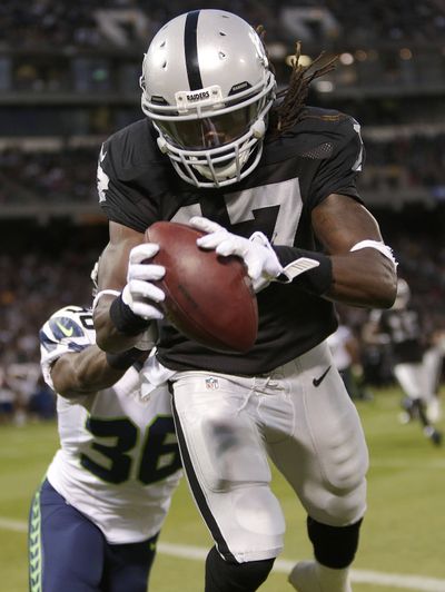 Oakland Raiders wide receiver Denarius Moore hauls in an 11-yard touchdown pass on Thursday. (Associated Press)