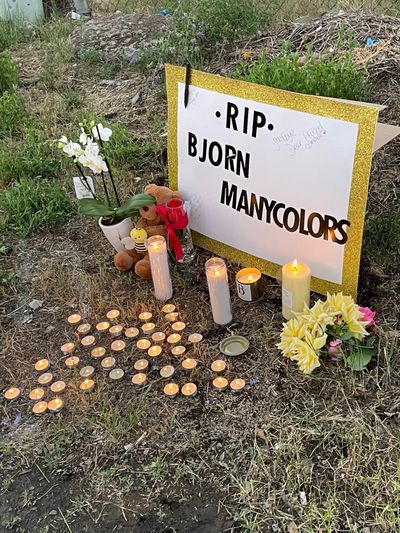 A sign remembering Bjorn Manycolors, who was shot and killed by deputies June 4, is propped up at a candlelight vigil for Manycolors on June 10 at North Dyer Road and East Mallon Avenue, near where Manycolors was shot.  (Garrett Cabeza / The Spokesman-Review)