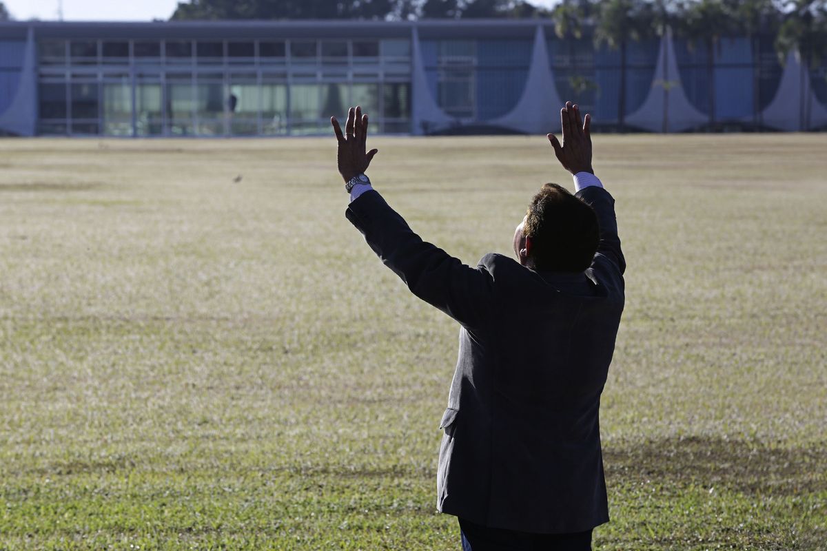 An evangelical pastor prays for Brazil