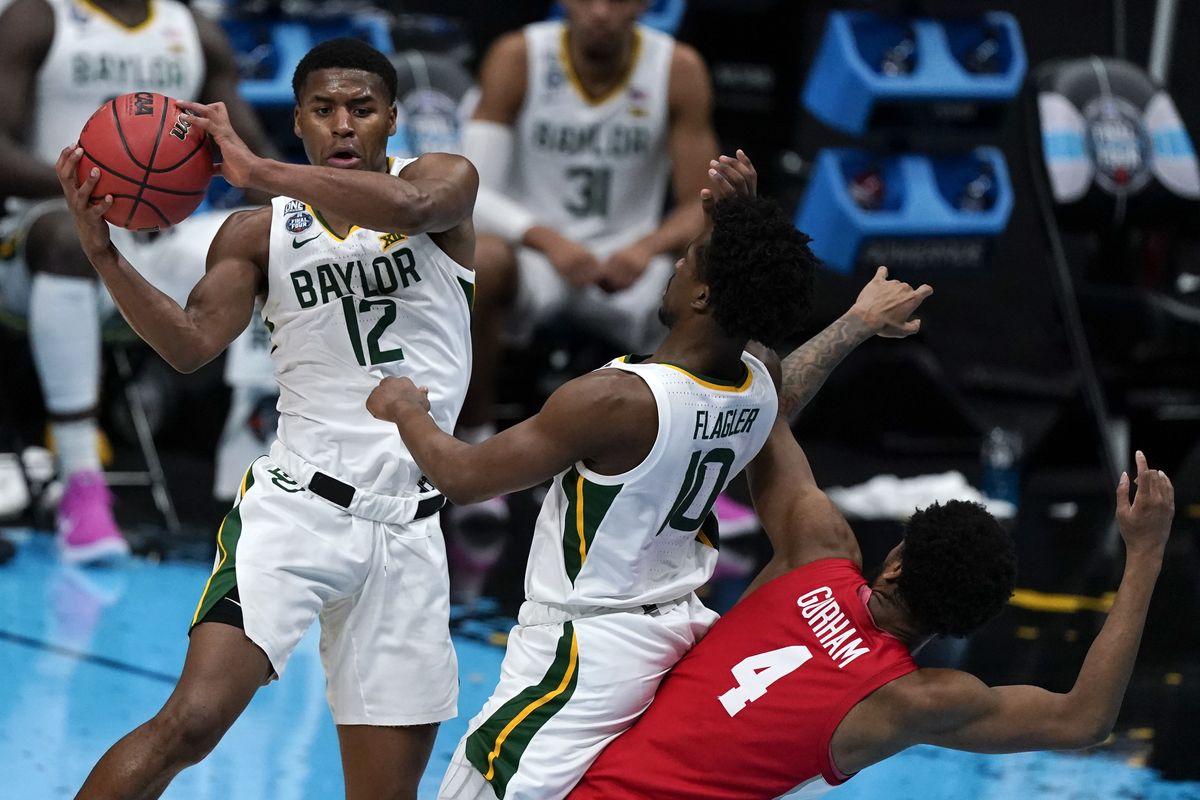 Baylor guard Jared Butler passes over teammate Adam Flagler and Houston forward Justin Gorham during Saturday’s NCAA Tournament Final Four game at Lucas Oil Stadium in Indianapolis. Baylor won 78-59 to advance to Monday’s championship game. (Associated Press)