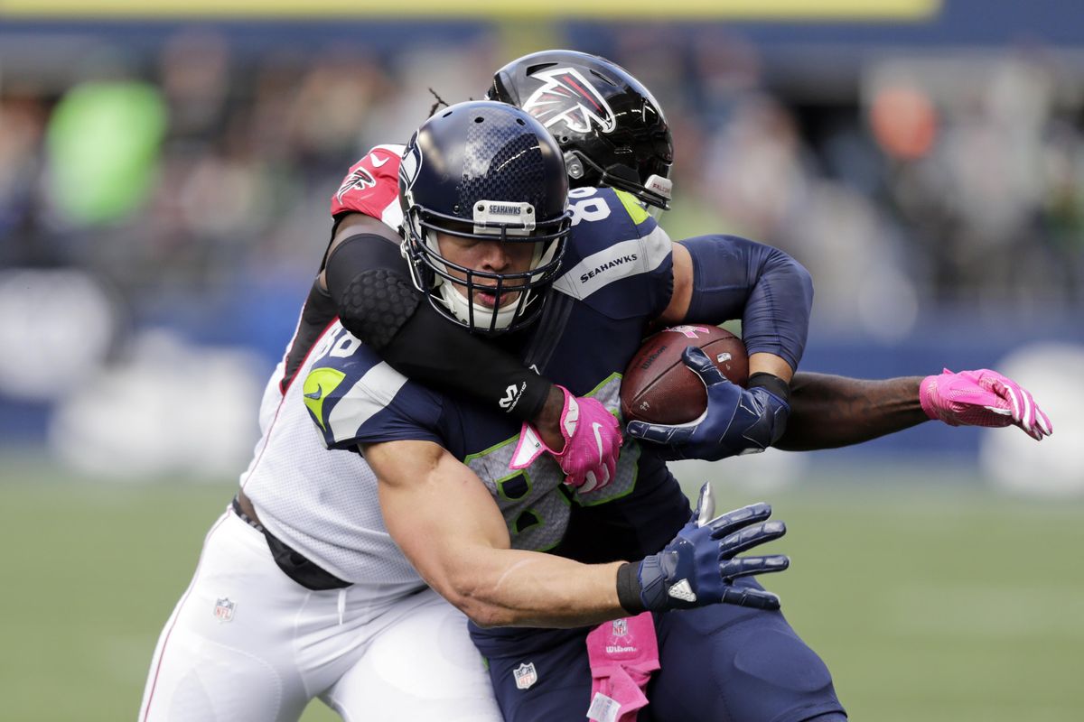 Falcons linebacker De’Vondre Campbell tackles Seahawks tight end Jimmy Graham on a pass play in the first half of Sunday’s game in Seattle. (Stephen Brashear / Associated Press)