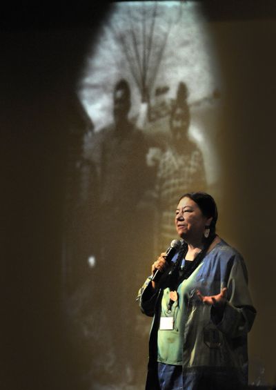 Theda New Breast connects with an audience of Indian youth Friday at the Spokane Convention Center during the 34th annual Northwest Indian Youth Conference. She is framed by a projected image of her grandparents at rear. She asked the audience, “What did your grandparents want for you? What have you done to honor them?”  (CHRISTOPHER ANDERSON / The Spokesman-Review)