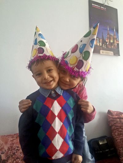 Abuzar Ahmad, left, the only surviving child of Agence France-Presse journalist Sardar Ahmad, who was killed with the rest of his family in an attack on a Kabul hotel, and his sister Nilofar pose for a picture during a birthday party in Kabul, Afghanistan, in January. (Associated Press)