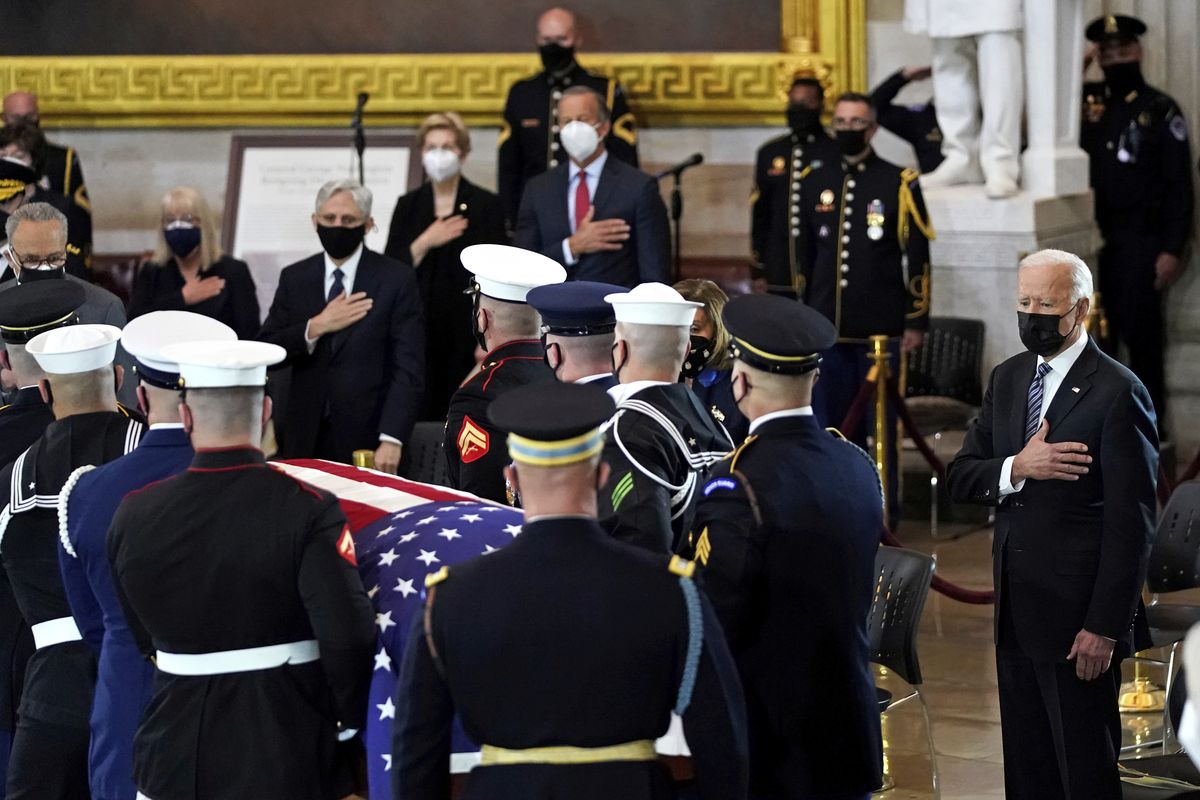 President Joe Biden stands as a joint services honor guard carries the flag-draped casket of U.S. Capitol Police officer William "Billy" Evans, to where he will lie in honor at the Capitol in Washington, Tuesday, April 13, 2021.  (Amr Alfiky)