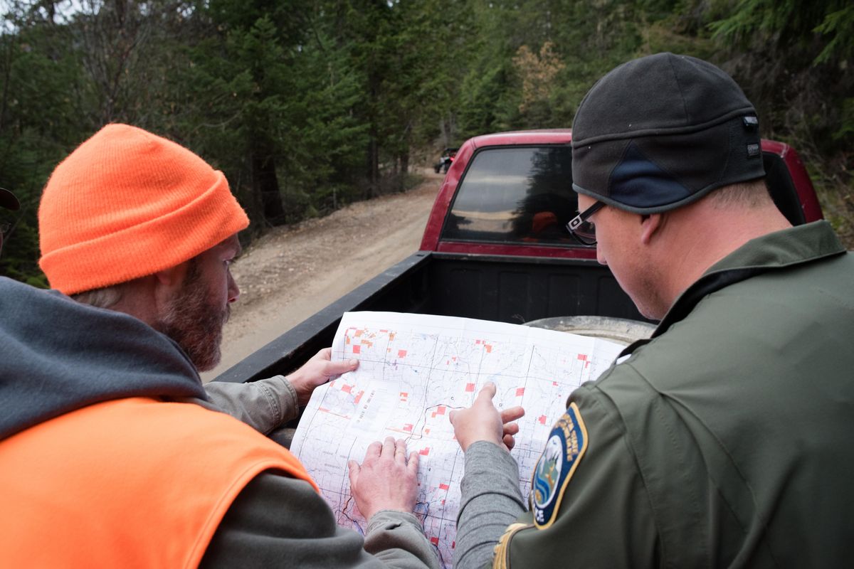 A hunter gives Washington Department of Fish and Wildlife Sergeant Tony Leonetti a tip about a deer he believes was killed out of season on Saturday Nov. 9, 2019. (Eli Francovich / The Spokesman-Review)