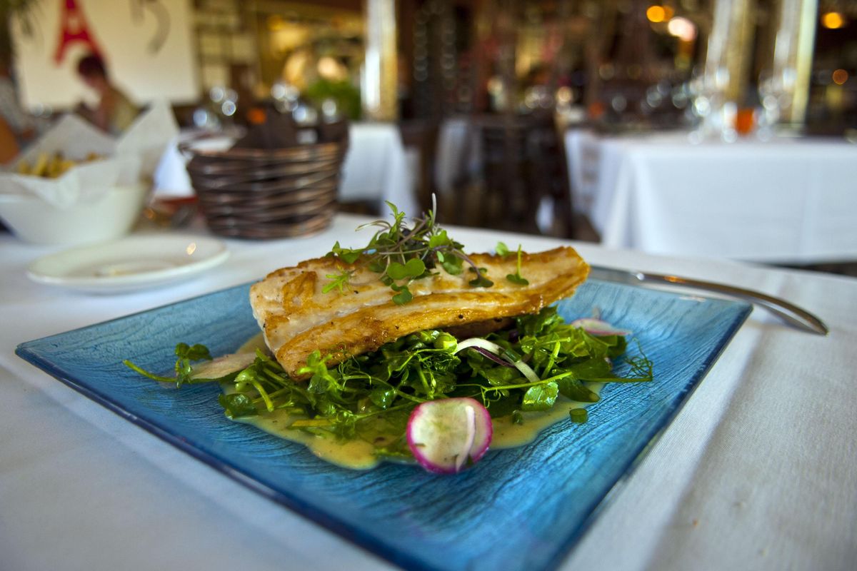 The "catch of the day" at Fleur De Sel restaurant in Post Falls was the fresh Baja Escolar with greens from local Ace of Spade farm that included radishes, pea shoots, Russian kale and crisp fingerling potatoes with white truffle oil vinagrette on Thursday, July 6, 2017. (Kathy Plonka / The Spokesman-Review)