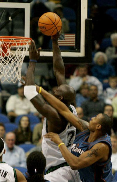 
Minnesota's Kevin Garnett is fouled by Washington's Caron Butler in the second quarter. 
 (Associated Press / The Spokesman-Review)