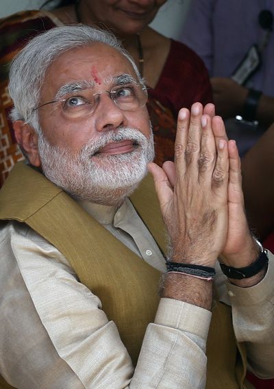 Narendra Modi, India’s next prime minister, greets a gathering at his mother’s home in Gandhinagar, in Gujarat state, on Friday. (Associated Press)