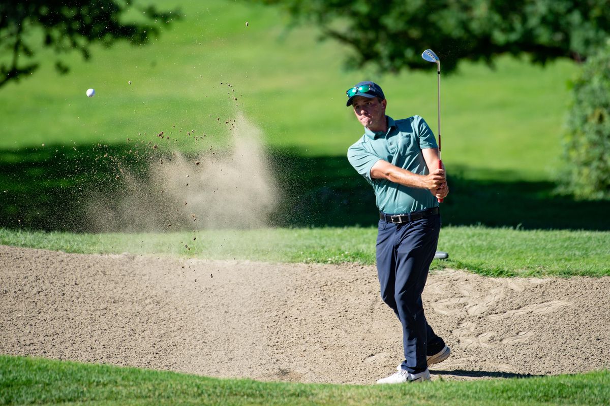 Jared Lambert sends up a spray of sand with his ball during a three-way tiebreaker on the 18th hole for the 32nd annual Rosauers Open Invitational title at Indian Canyon Golf Course on Sunday, July 21, 2019. (Libby Kamrowski / The Spokesman-Review)