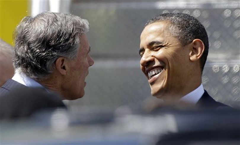 President Barack Obama greets former Washington Rep. Jay Inslee, who is currently a Democrat running for governor, after Obama arrived in Seattle, Thursday, May 10, 2012. Obama was in town for fund-raising events. (Ted S. Warren/Associated Press)