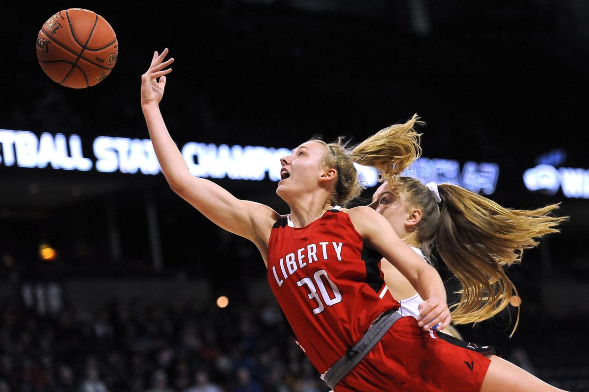 Aleena Cook (30) of the Liberty Lancers takes a shot against the La Conner Braves during the girls 2B basketball tournament at the Spokane Arena on Saturday, March 7, 2020. (Kathy Plonka / The Spokesman-Review)