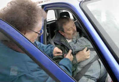 
Volunteer Kay Conklin assists Charles McNew into her car in front of the Parsons Apartment in Spokane. Conklin picked up McNew to take him grocery shopping. 
 (Dan Pelle / The Spokesman-Review)