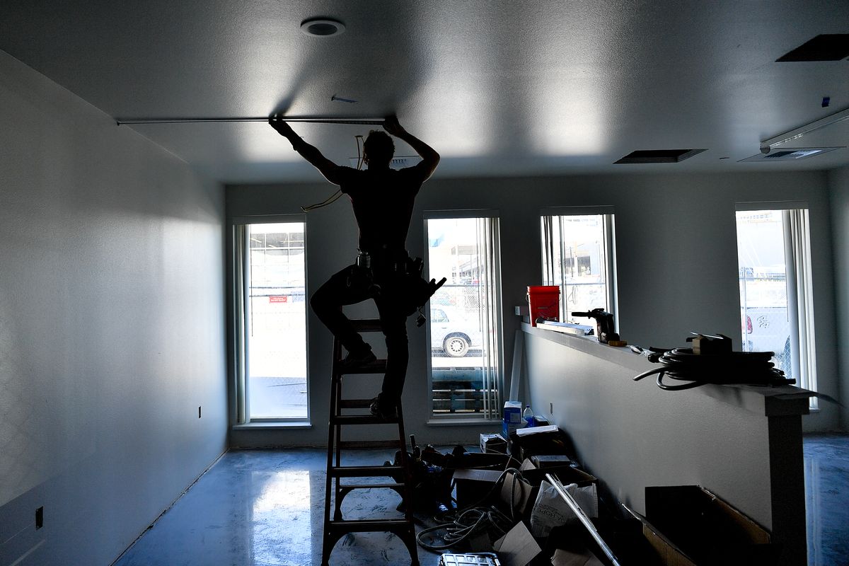 James McAllister, an electrician with Vector Electric, works to wire in fixtures on Wednedsay for the still-under-construction new Hope House women’s shelter at Hope House, Wash.  (Tyler Tjomsland/The Spokesman-Review)
