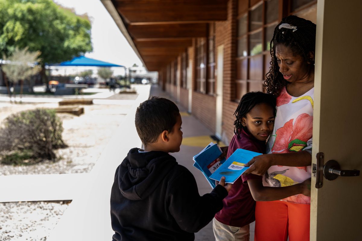 Martin Luther King Jr. Elementary School teacher Bobbie Watterson hugs a student outside the classroom in Phoenix in May. (Melina Mara/The Washington Post)