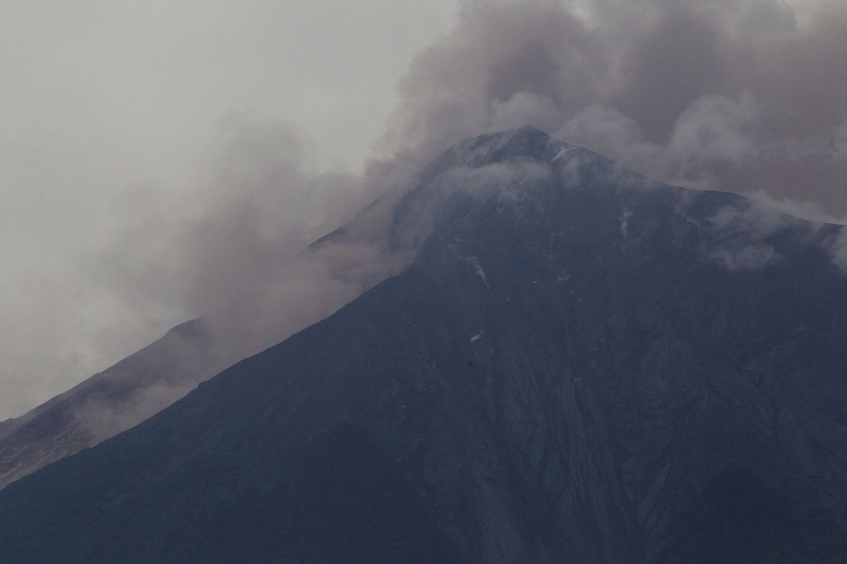 Volcan de Fuego, or Volcano of Fire, blows outs a thick cloud of ash, as seen from Alotenango, Guatemala, Sunday, June 3, 2018. One of Central America