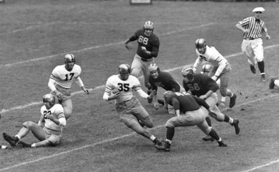 Felix Blanchard (35) weaves away from three Michigan defenders in a 1945 game. (File Associated Press / The Spokesman-Review)