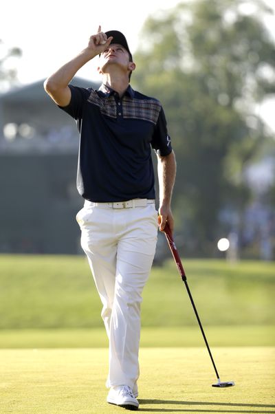Justin Rose looks to the sky in honor of his late father after putting on the 18th green at Merion. (Associated Press)