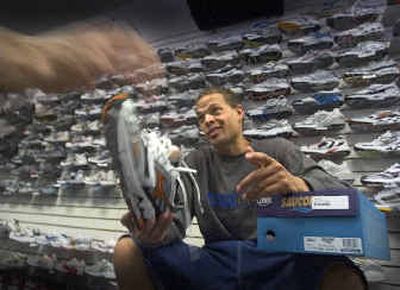 
Branden Fuller helps a customer pick out running shoes at The Runners Soul in downtown Spokane. He's worked at the store for five years.
 (Christopher Anderson/ / The Spokesman-Review)