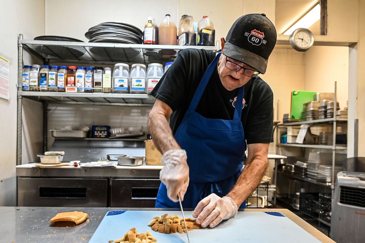 John Davis cuts croutons in the kitchen of the Broadway Diner on Thursday.  (DAN PELLE/THE SPOKESMAN-REVIEW)