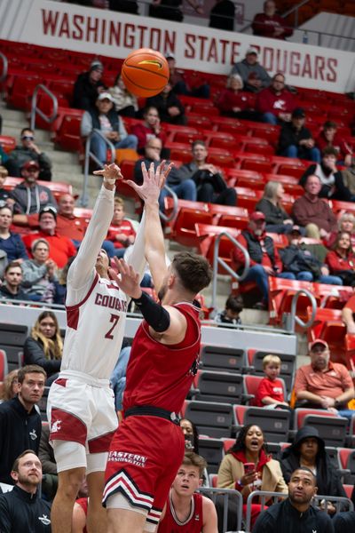 Washington State guard Myles Rice, left, puts up a three-point shot in the first half against Eastern Washington on Monday, Nov. 27, 2023 at the Beasley Coliseum in Pullman, Wash.  (Geoff Crimmins/For The Spokesman-Review)