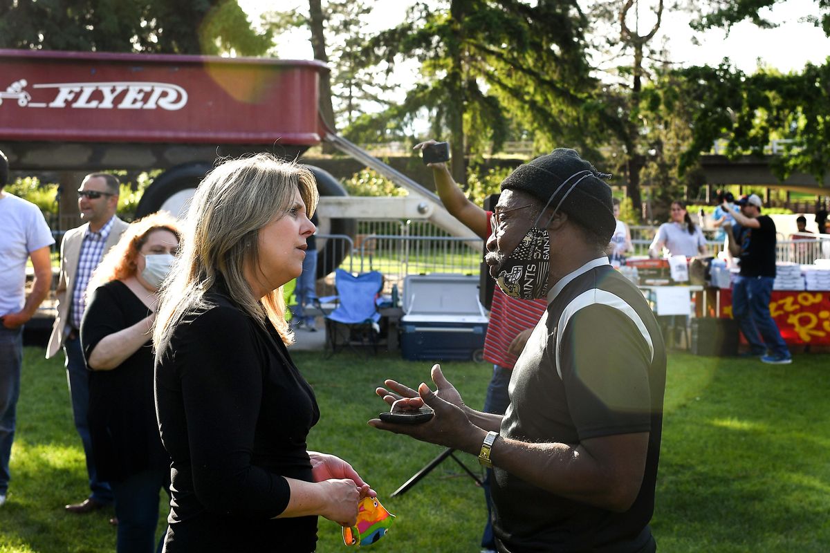 Nadine Woodward talks with Bertram Price, right, during a protest on Wednesday, June 3, 2020, at Riverfront Park in Spokane, Wash. 