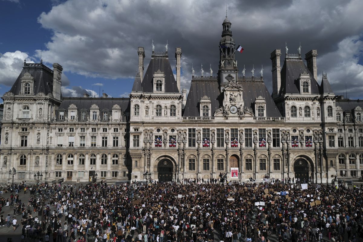 A woman holds a board reading