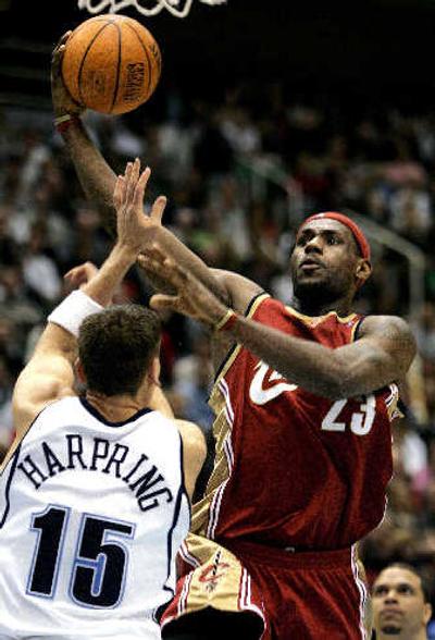 
Cleveland's LeBron James scores against Utah's Matt Harping during the second quarter. 
 (Associated Press / The Spokesman-Review)