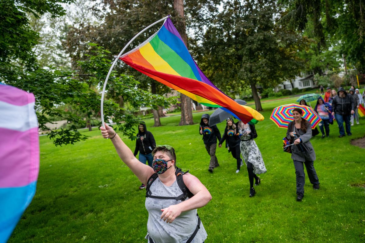 As part of the Pride in the Park event, April Hoy waves a rainbow flag during the “Pride Stride” march in Coeur d’Alene City Park, Saturday, June 11, 2022. Pride in the Park is North Idaho Pride Alliance
