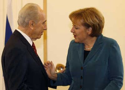 
Israeli President Shimon Peres welcomes German Chancellor Angela Merkel  at his residence in Jerusalem on Tuesday during her  three-day  visit to Israel. Associated Press
 (Associated Press / The Spokesman-Review)
