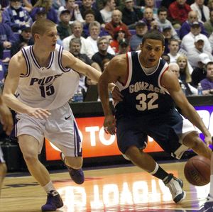 Gonzaga’s Steven Gray drives past Portland’s Nik Raivio during the first half of Thursday’s game in Portland.  (Associated Press / The Spokesman-Review)