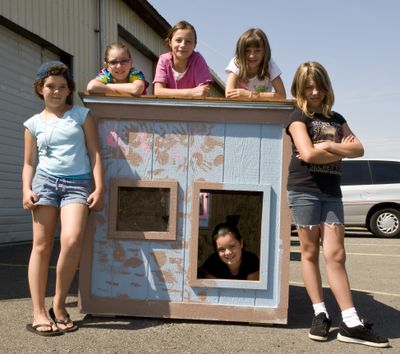 From left are Ahlea Willard, Hana Knowlton, Tessa Brockmier, Rebecca Storlie, Emily Najar and, in the dog house, Rylie Melton. The children helped build the canine shelter and learned other good-pet-owner skills as part of a SpokAnimal program called Outdoor Upstart Training Together!  (Colin Mulvany / The Spokesman-Review)