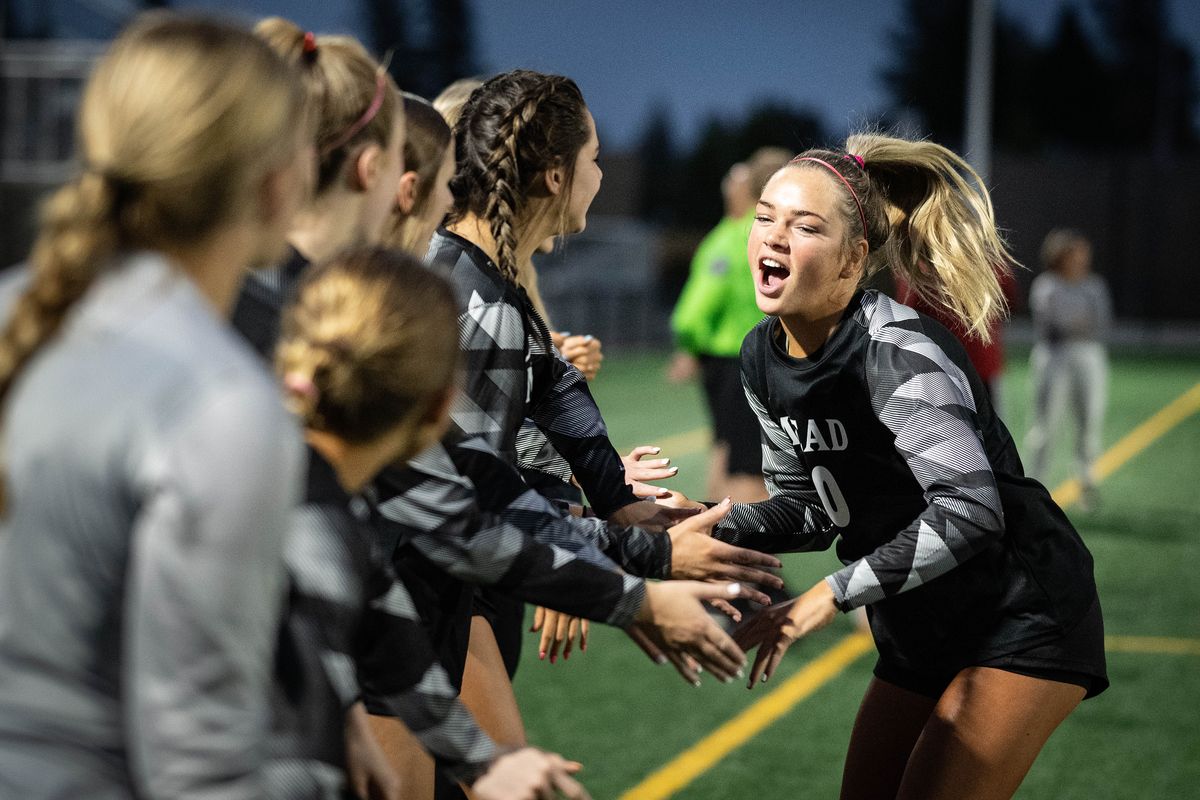 Mead girls soccer player Teryn Gardner slaps hands with teammates during player introductions before the Panthers’ soccer match against Ferris on Monday at Union Stadium.  (COLIN MULVANY/THE SPOKESMAN-REVI)