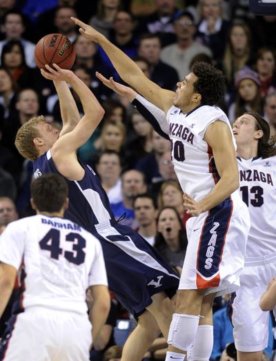 Gonzaga's Elias Harris (20) and Kelly Olynyk (13) contest a shot by BYU's Tyler Haws (3). (Colin Mulvany)