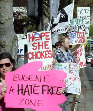 Protestors hold signs outside the hotel where Sarah Palin, former vice presidential candidate and Alaskan governor,  is scheduled to speak to a gathering of Lane County Republicans in Eugene, Ore. on Friday, April 23, 2010. (Don Ryan / Associated Press)