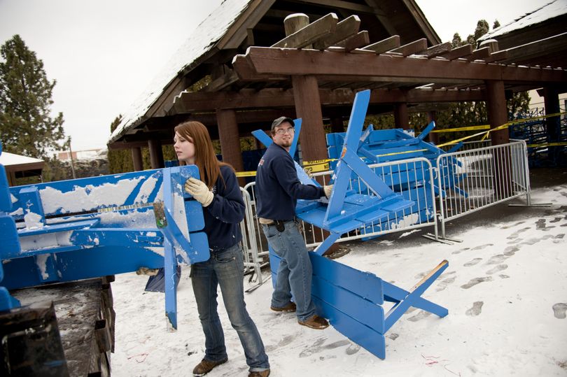 Nikki Moseanko and Dan Burrows, Spokane Parks and Recreation Department, load some of the 11 damaged park picnic tables to be repaired from the North Bank shelter area, Dec. 26, 2012 in Riverfront Park. After vandals stacked the tables forming a Christmas tree with ornaments, the structure collapsed and was discovered Christmas morning. Work crews, including Moseanko were called into duty in the morning hours of Christmas to secure the mess.  (Dan Pelle)