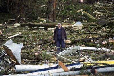 
Bill Kalenius,  founder of the Vancouver Lake Crew, surveys the total destruction of the club's boats and rowing headquarters after a tornado touched down Thursday in Vancouver, Wash., downing  power lines and uprooting  trees. 
 (Associated Press / The Spokesman-Review)