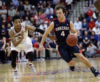 Kevin Pangos, right, scored only five points but made a big contribution on defense against Broncos’ Brandon Clark, left. (Associated Press)