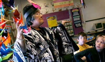 
Teacher Lillian Smith talks about the symbolism behind the origami cranes hanging in her room during International Day at Opportunity Elementary School Friday afternoon. Smith, who will retire from the school this year, has taught in Japan, Okinawa and Germany through the Department of Defense. 
 (Holly Pickett / The Spokesman-Review)