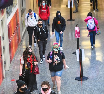 North Central High School students keep to the right in the hallways and throughout the building as they attend in-person classes for the first time this school year, March 1, in Spokane. (DAN PELLE/THE SPOKESMAN-REVIEW)