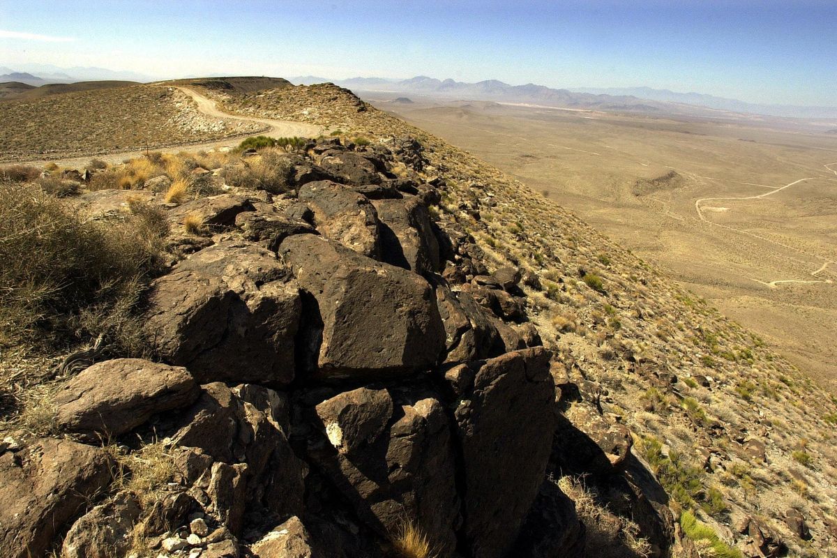FILE - In this June 25, 2002 file photo, the view from the summit ridge of the proposed Yucca Mountain nuclear waste dump near Mercury, Nev., looking west towards California. For two decades, a ridge of volcanic rock 90 miles northwest of Las Vegas known as Yucca Mountain has been the sole focus of government plans to store highly radioactive nuclear waste. Thursday, Energy Secretary Steven Chu told a Senate hearing that the Yucca Mountain site no longer was viewed as an option for storing reactor waste, brushing aside criticism from several Republican lawmakers. (JOE CAVARETTA / Associated Press)